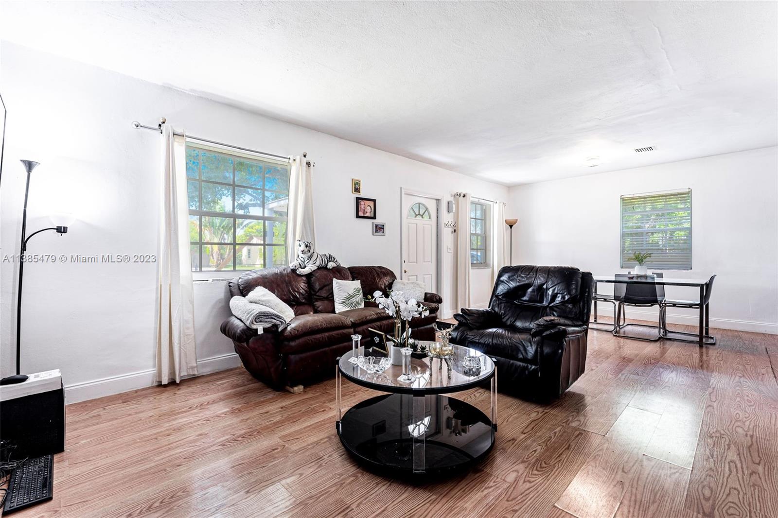 8241 Southwest 37th Street Miami, FL 33155 - Photo 17 of 46 a living room with furniture and a wooden floor
