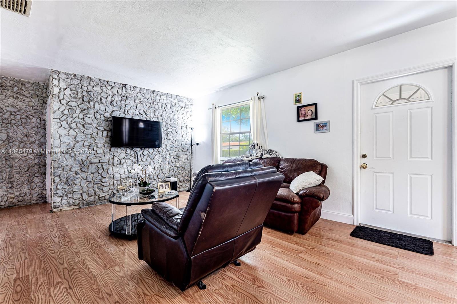 8241 Southwest 37th Street Miami, FL 33155 - Photo 18 of 46 a living room with furniture and a flat screen tv