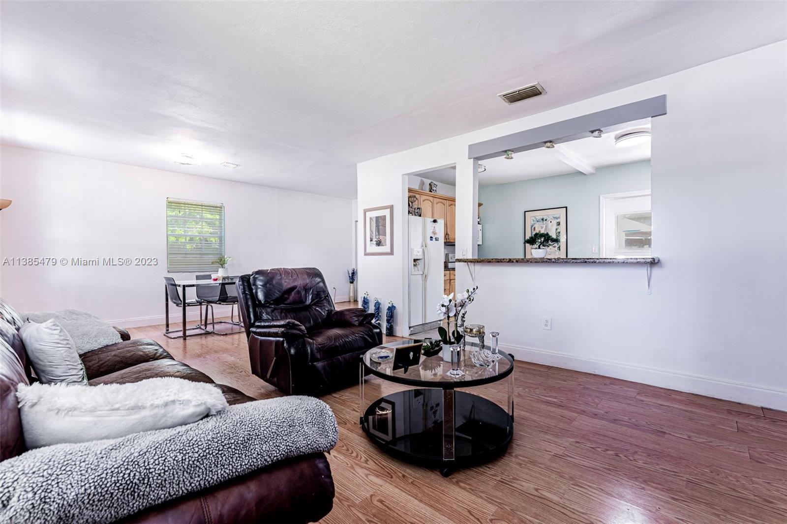 8241 Southwest 37th Street Miami, FL 33155 - Photo 19 of 46 a living room with furniture and wooden floor