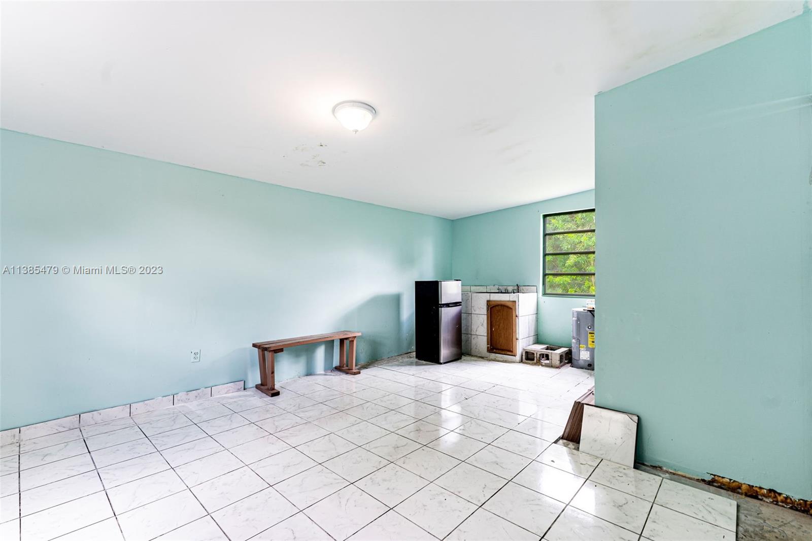 8241 Southwest 37th Street Miami, FL 33155 - Photo 29 of 46 a bedroom with a bed and a night stand