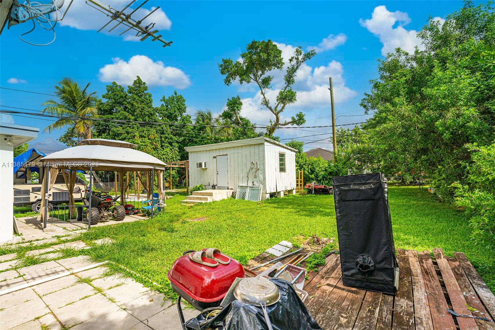 8241 Southwest 37th Street Miami, FL 33155 - Photo 39 of 46 a view of a table and chairs in patio under a large tree