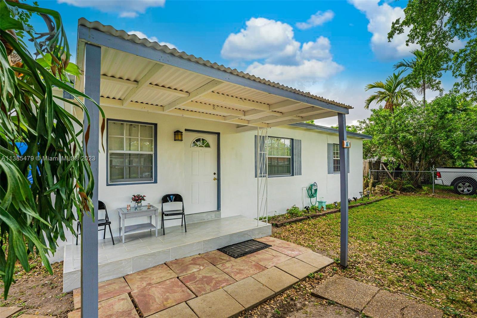8241 Southwest 37th Street Miami, FL 33155 - Photo 4 of 46 a view of a patio with table and chairs with wooden fence and plants