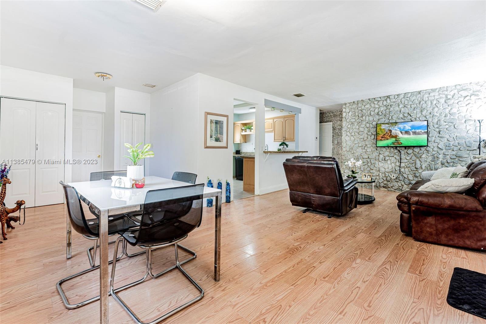 8241 Southwest 37th Street Miami, FL 33155 - Photo 7 of 46 a living room with furniture and a flat screen tv