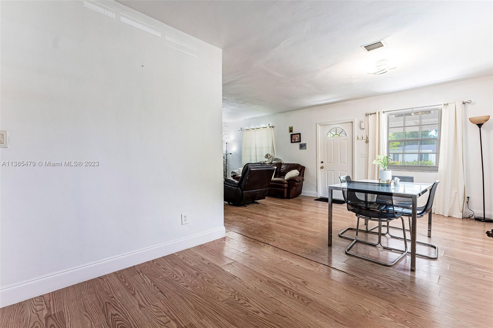 8241 Southwest 37th Street Miami, FL 33155 - Photo 8 of 46 a living room with furniture a dining table and a window