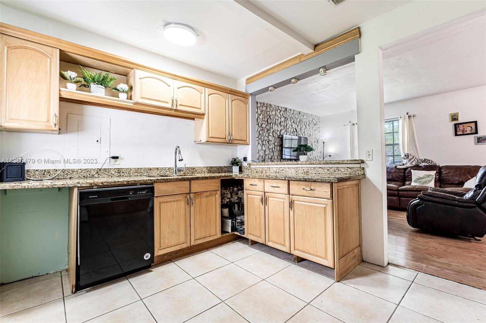 8241 Southwest 37th Street Miami, FL 33155 - Photo 9 of 46 a kitchen with a sink stove and cabinets