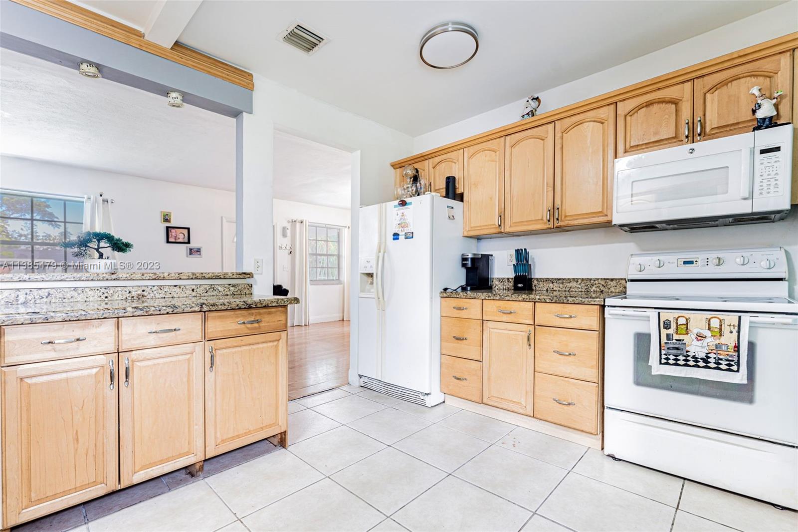 8241 Southwest 37th Street Miami, FL 33155 - Photo 10 of 46 a kitchen with granite countertop cabinets stainless steel appliances and a sink