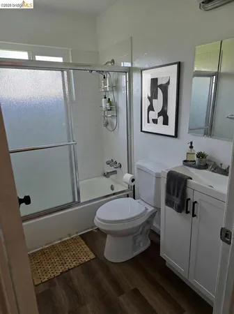 a bathroom with a toilet a sink and shower