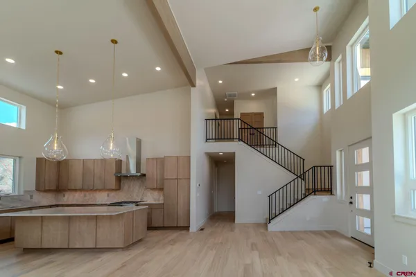 a kitchen with stainless steel appliances granite countertop a refrigerator and a stove top oven