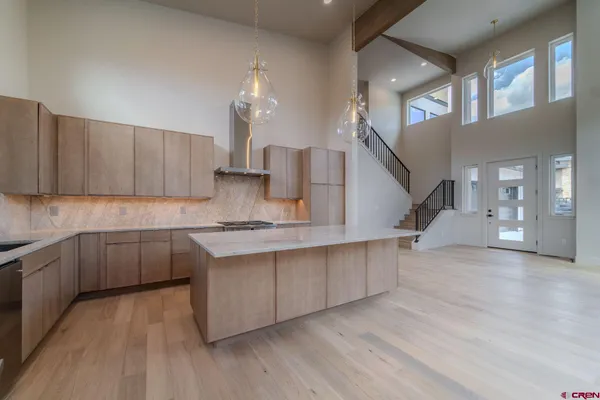 a kitchen with stainless steel appliances granite countertop a refrigerator and a sink