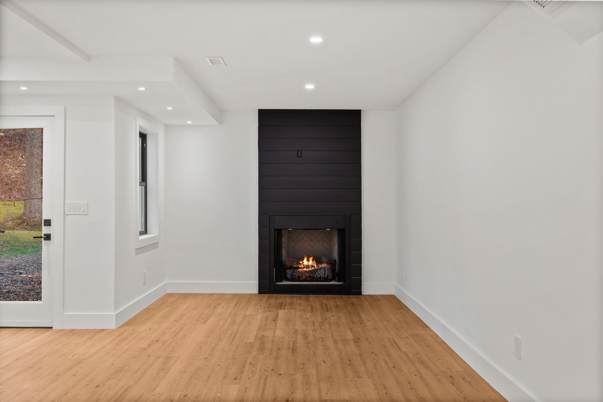 3945 New Highway 96 West Franklin, TN 37064 - Photo 58 of 69 a view of an empty room with wooden floor and a fireplace