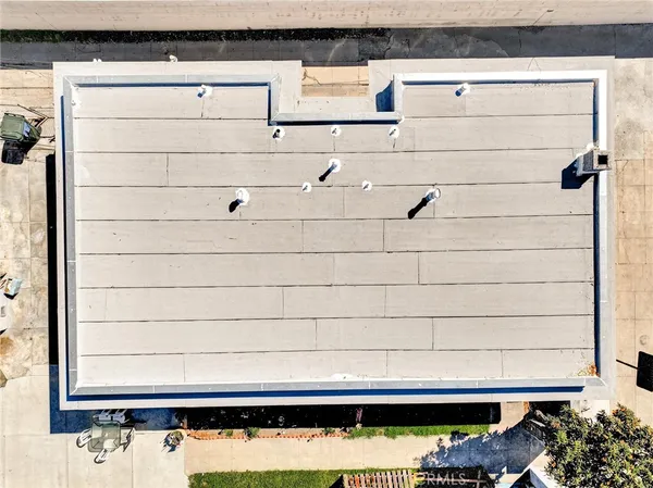 a roof deck with table and chairs a barbeque