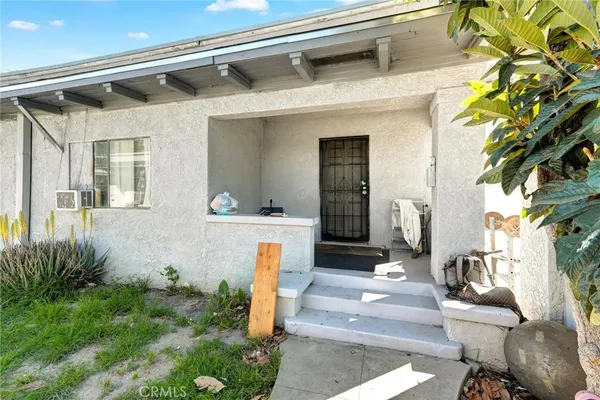 a front view of a house with outdoor seating and plants