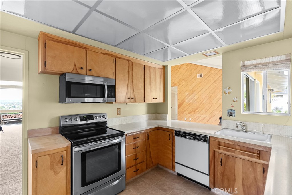 2 Cambridge Drive Lompoc, CA 93436 - Photo 18 of 27 a kitchen with stainless steel appliances a stove sink microwave and cabinets