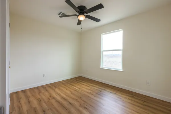 a view of a room with wooden floor