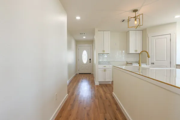 a kitchen with a sink cabinets stainless steel appliances and a window