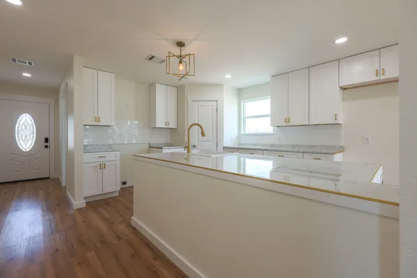 a kitchen with a sink stove and cabinets