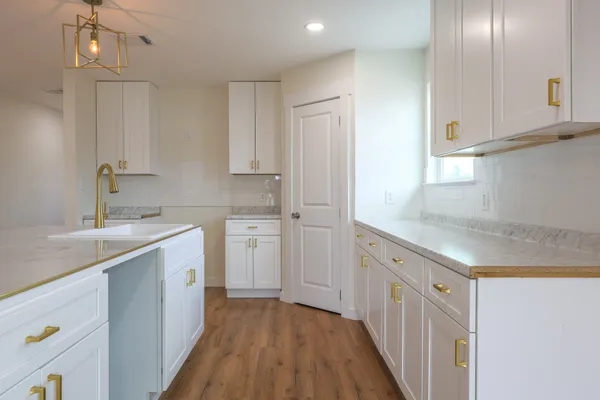 a kitchen with a refrigerator sink and cabinets