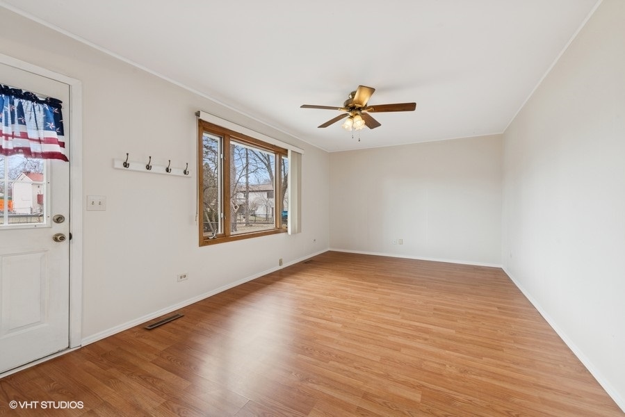 544 Arthur Drive Cary, IL 60013 - Photo 9 of 23 a view of empty room with wooden floor and fan