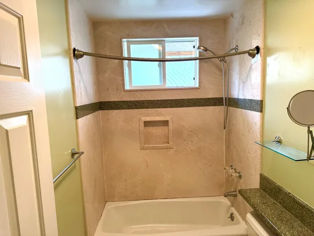 a bathroom with a shower and a sink