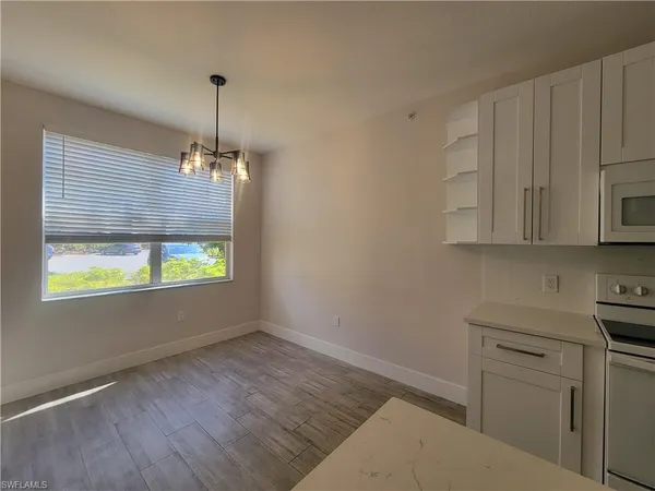 a view of a kitchen with an empty space and a window