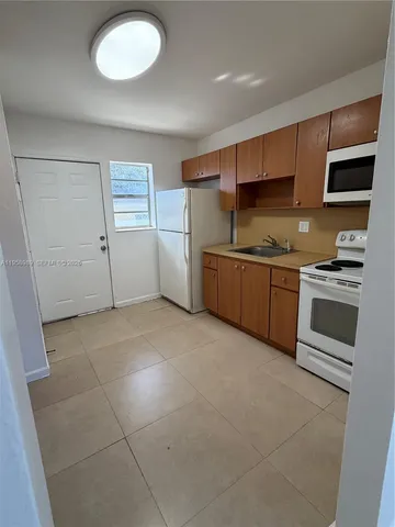 a kitchen with stainless steel appliances a stove sink and microwave