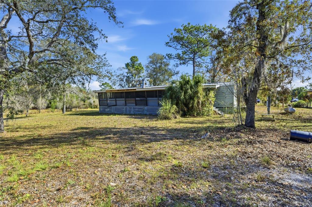 8045 Indian Trail Road Weeki Wachee, FL 34613 - Photo 37 of 49 a view of a garden with large trees