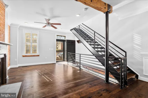 a view of entryway and hall with wooden floor