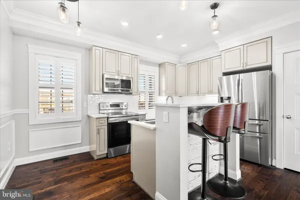 a kitchen with a sink stove top oven and refrigerator