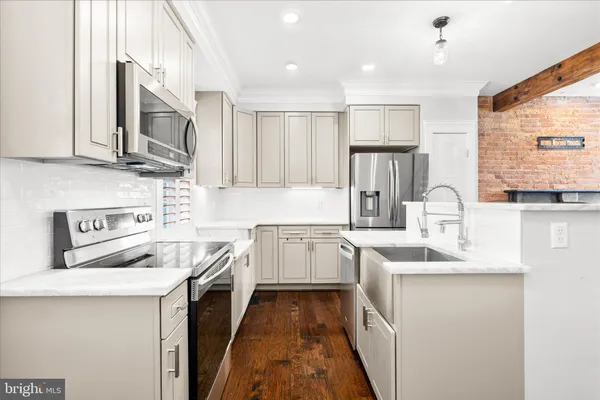 a kitchen with a sink stove and microwave