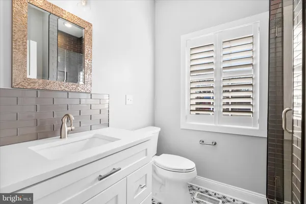 a bathroom with a sink a mirror and a shower