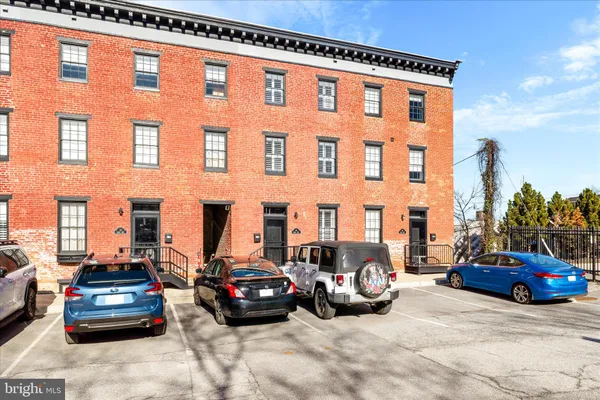 a view of a car is parked in front of a building