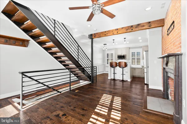 a living room with furniture a rug and white walls