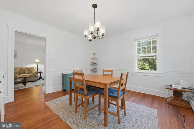 a view of a dining room with furniture wooden floor and a chandelier