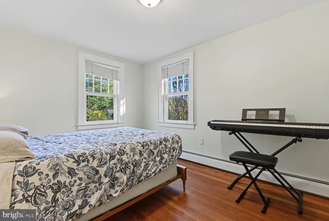 a bedroom with a bed window and chair