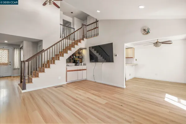 a view of a hallway with wooden floor and staircase