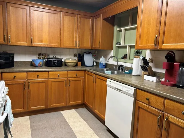 a kitchen with stainless steel appliances granite countertop a sink a stove and cabinets