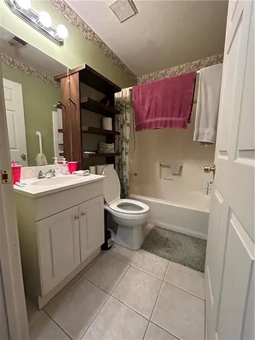 a bathroom with a sink mirror vanity and toilet