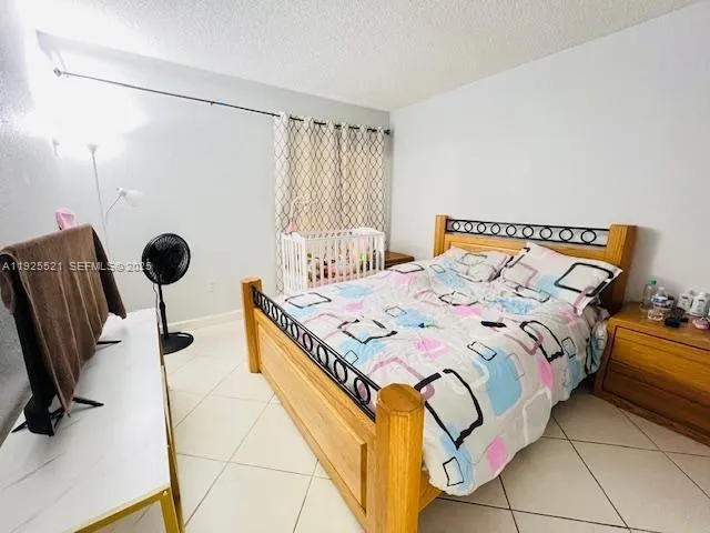 a bedroom with a bed chair and window