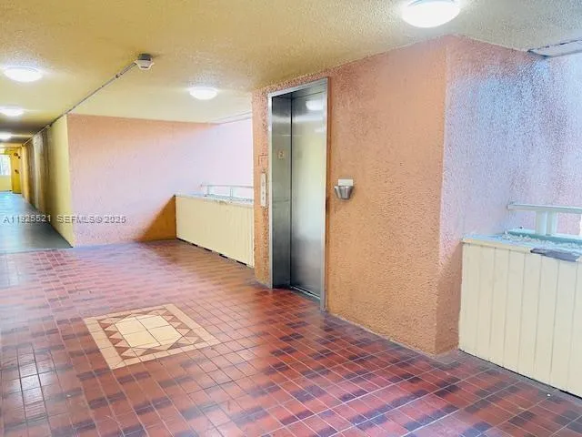 a view of an empty room and bathroom