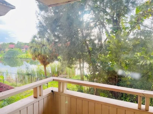 a view of a balcony with wooden fence