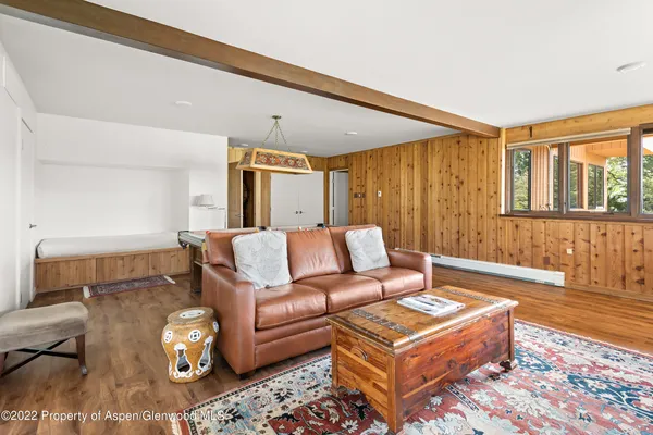 a view of a room with furniture a chandelier and wooden floor