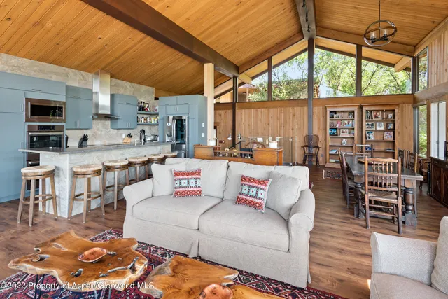 a living room with furniture a fireplace and a table