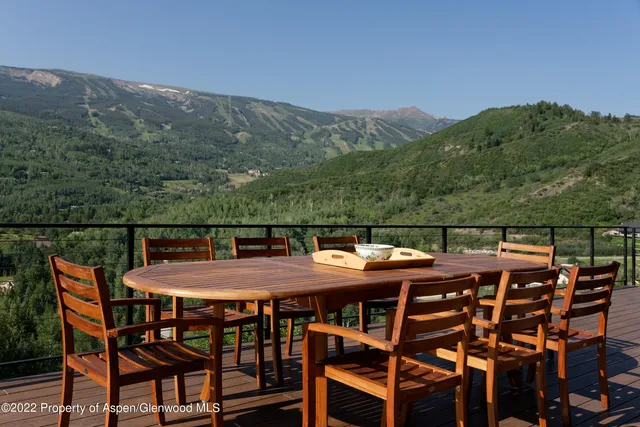 a view of house with backyard and sitting area
