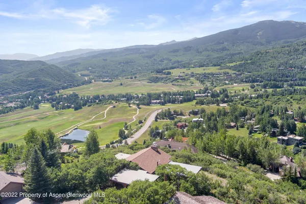 an aerial view of a house with a yard