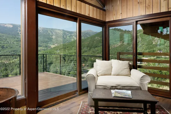 a living room with furniture and a floor to ceiling window