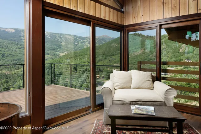 a living room with furniture and a floor to ceiling window