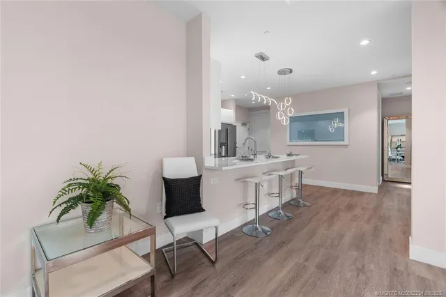 a kitchen with stainless steel appliances kitchen island hardwood floor sink and stove