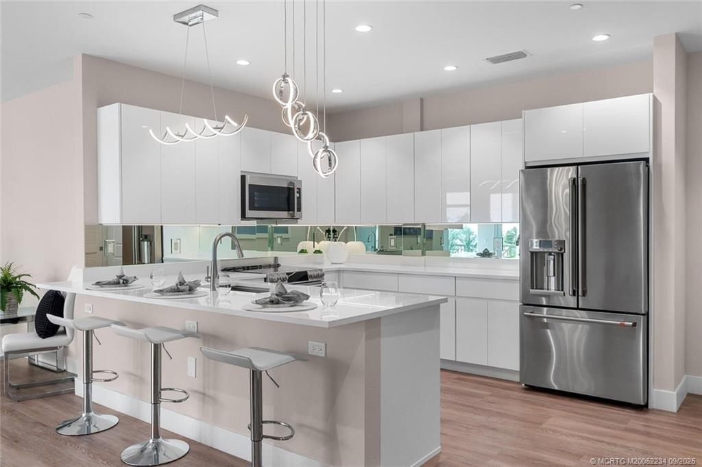 Undisclosed Address Stuart, FL 34994 - Photo 18 of 58 a kitchen with stainless steel appliances granite countertop a refrigerator a sink a stove a microwave and a refrigerator