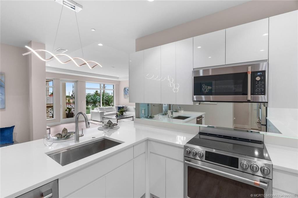 Undisclosed Address Stuart, FL 34994 - Photo 22 of 58 a kitchen with a sink stove and microwave