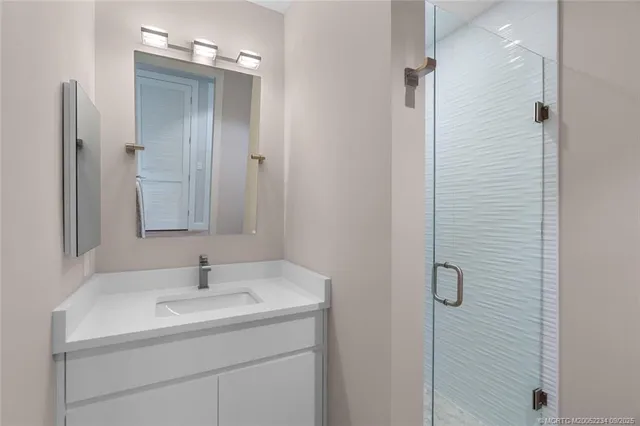 a bedroom with a bed and a mirror